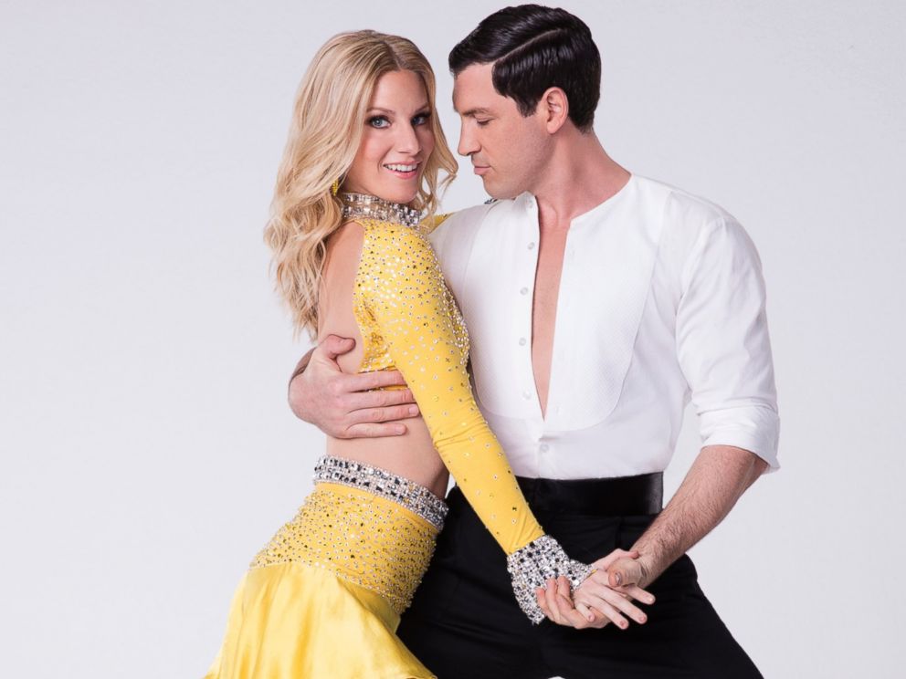 Heather Morris wears a sparkly yellow two piece costume as she poses with her 'Dancing With the Stars' partner, Maksim Chmerkovskiy.