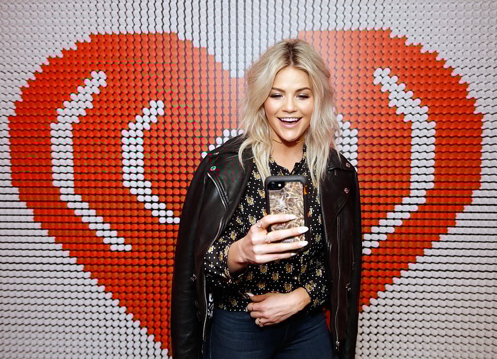 Witney Carson poses with her phone