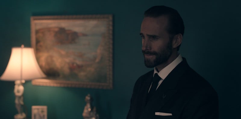 The Commander is in a suit and looking serious in The Handmaid's Tale.