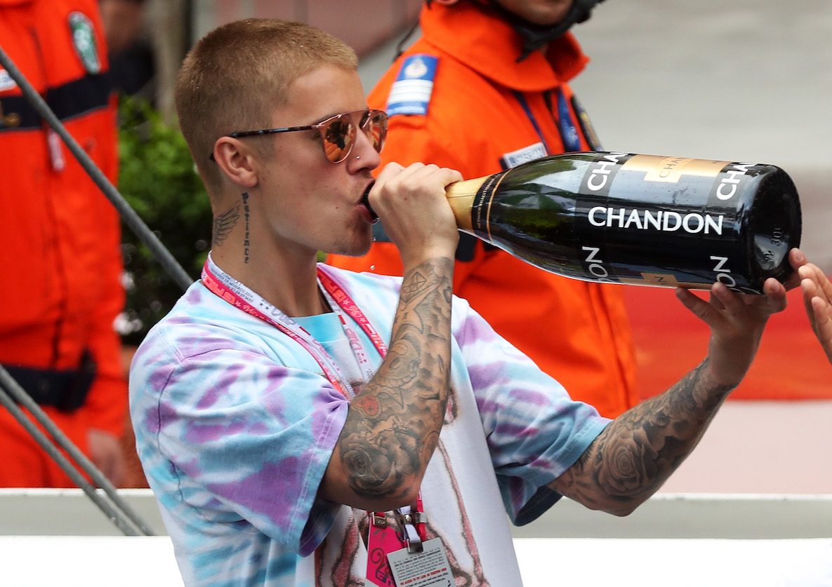 Justin Bieber drinks Chandon champagne out of a huge bottle during the F1 Grand Prix of Monaco.