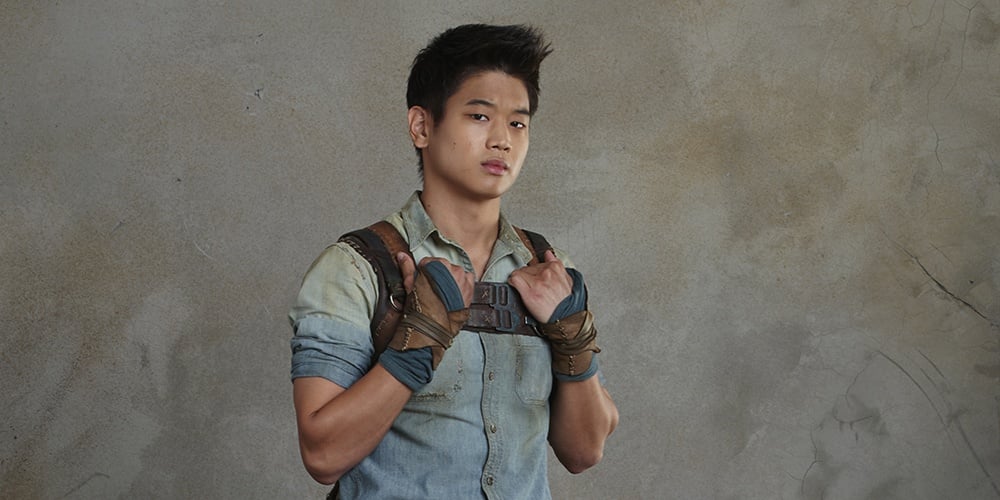 Ki Hong Lee with his hands on his shoulders, posing for a Maze Runner promo image