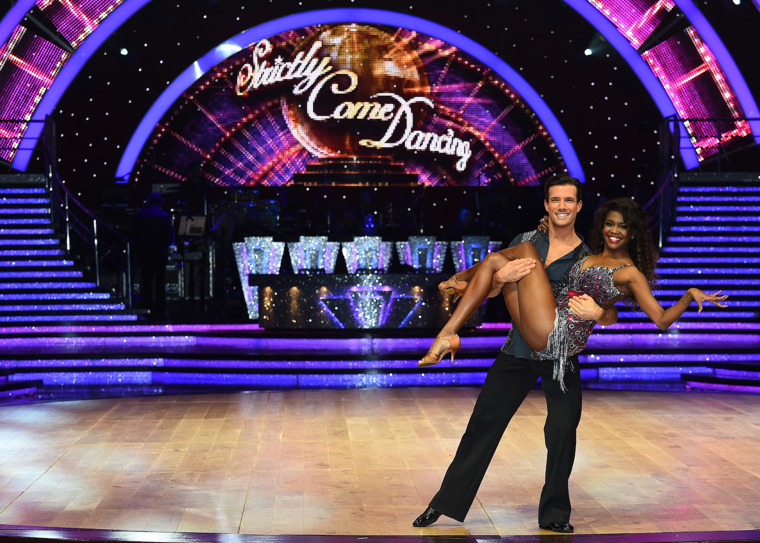 Two contestants pose on the stage for 'Strictly Come Dancing.'