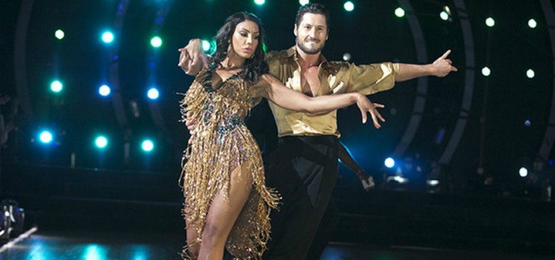 Tamar Braxton and Val Chmerkovskiy are dancing in gold outfits on 'Dancing with the Stars.'
