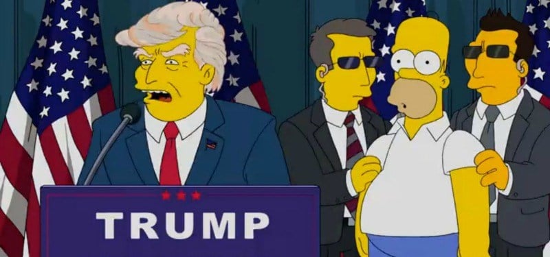 Donald Trump is at a podium while Homer is behind him between two secret service officers.