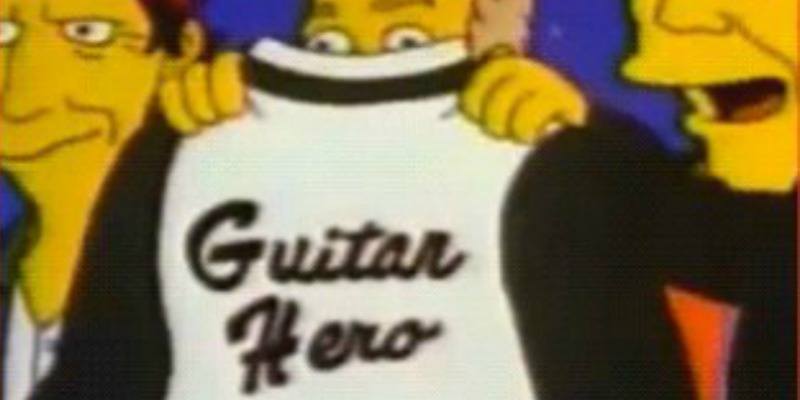 A man is holding up a jacket that says "guitar hero" in The Simpsons.
