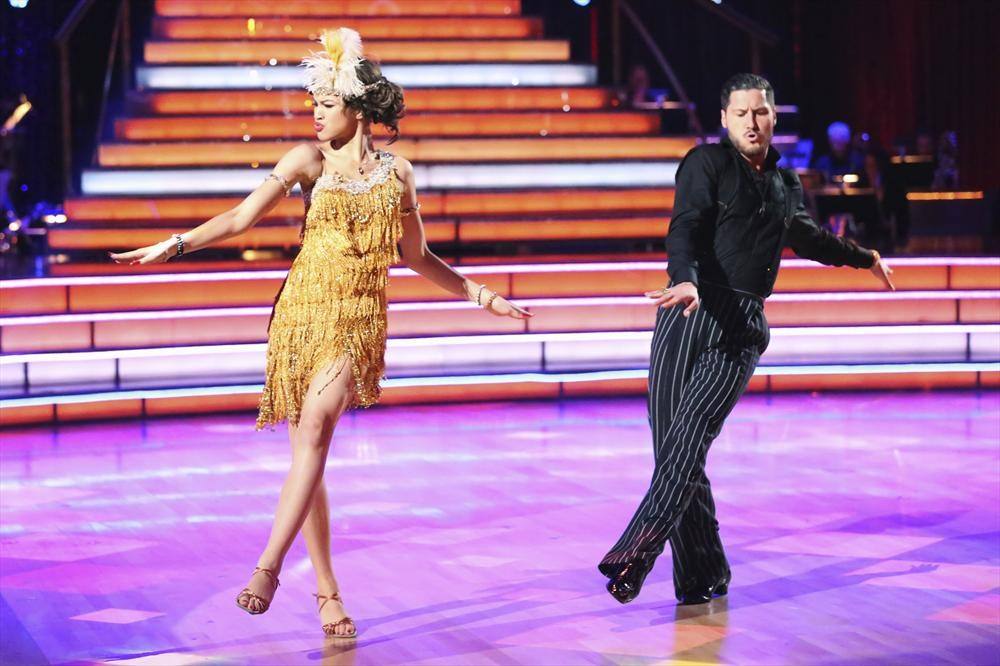 Zendaya Coleman wears a gold fringe dress as she dances next to Val Chmerkovskiy on 'Dancing With the Stars.'