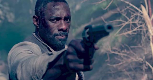 Idria Elba holds up a gun in The Dark Tower