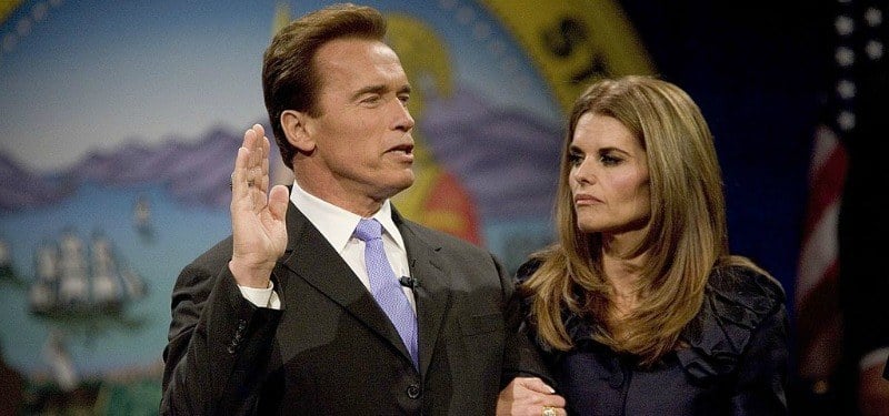 Arnold Schwarzenegger and Maria Shriver stand together as he is being sworn into office.