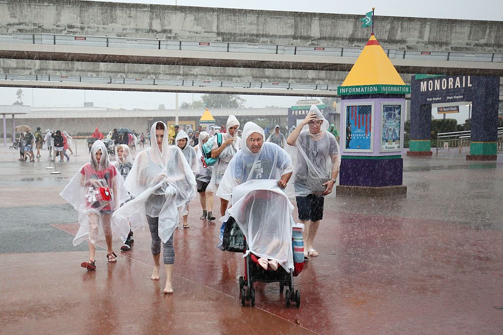 People leave Disney's Magic Kingdom theme park