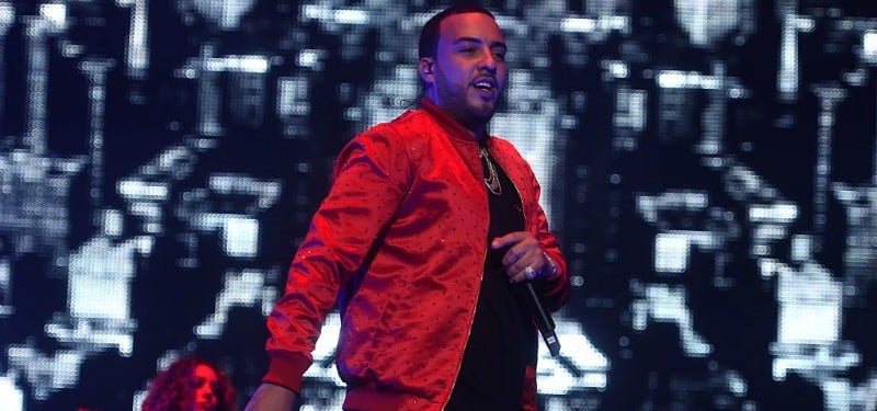 French Montana is wearing a red jacket and is on stage.