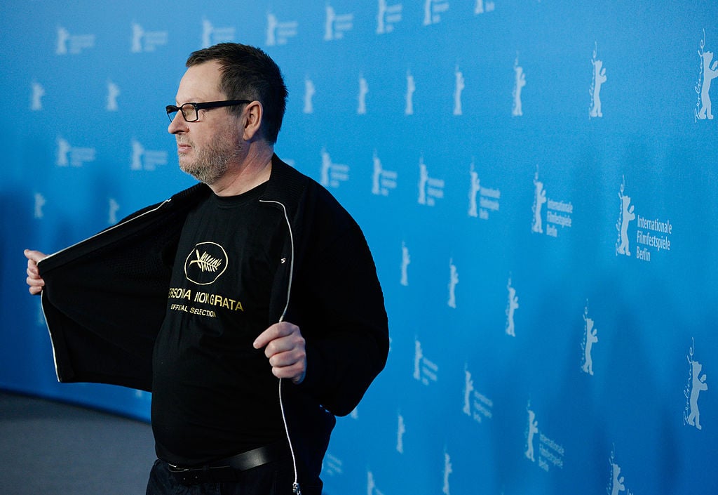 Lars Von Trief, holding his sweartshirt open on the red carpet