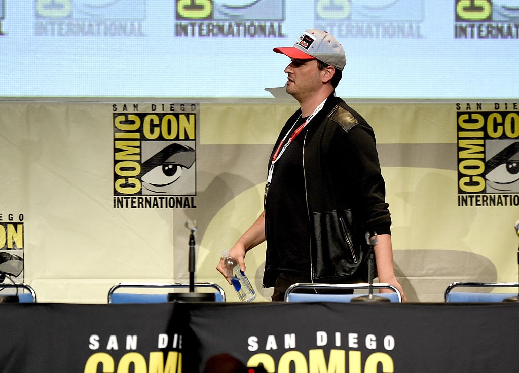Josh Trank in a ballcap, walking on-stage at Comic-Con