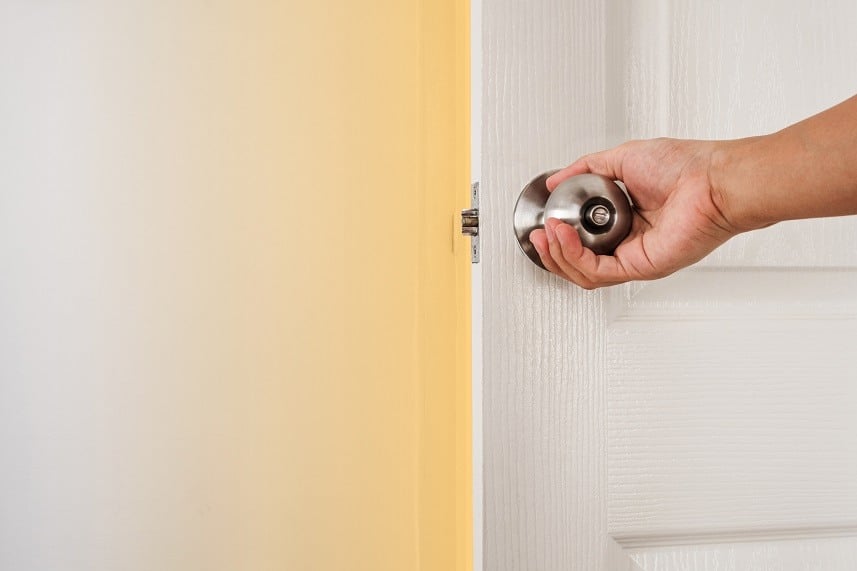 Hand holding door knob