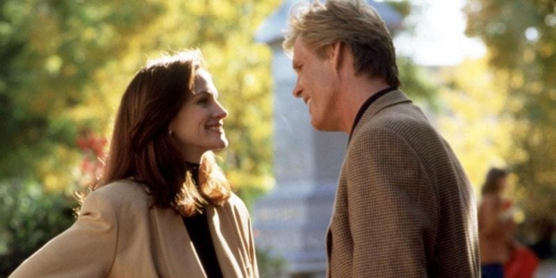 Julia Roberts and Nick Notle look at each other smiling in a park in I Love Trouble.