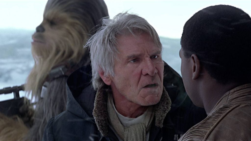 Han standing in front of Chewie, angrily lecturing Finn