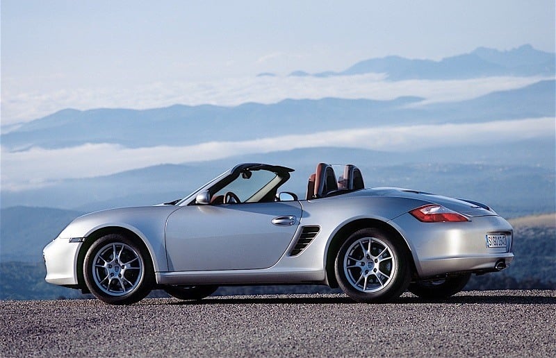 View of a silver 2006 Porsche Boxster roadster with the top down at dusk