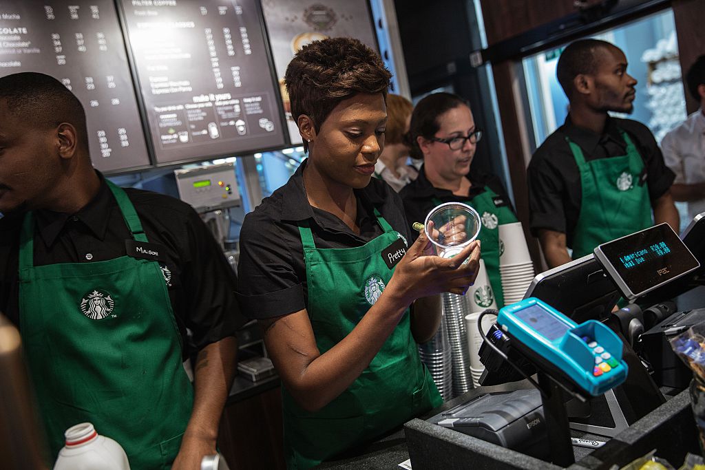 starbucks employees work behind the counter