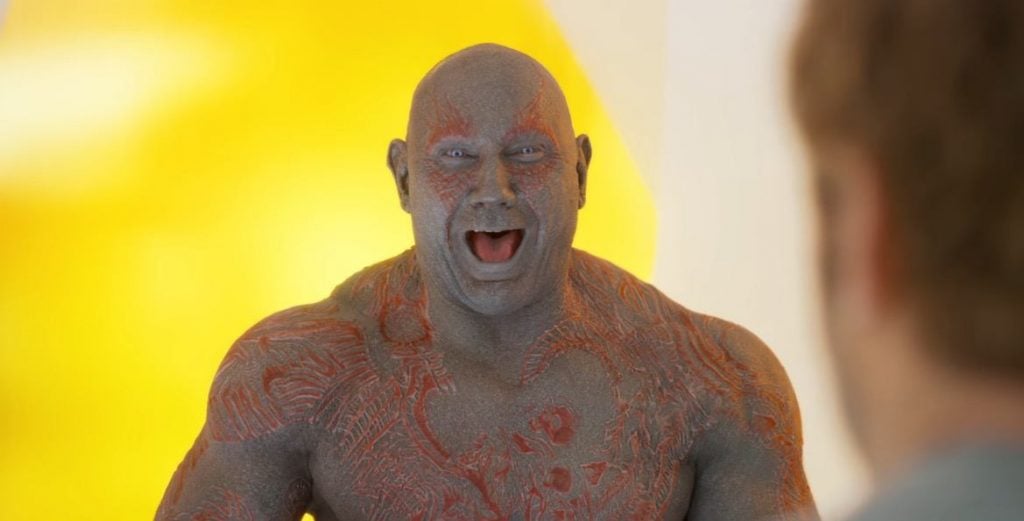 Drax smiling and laughing in a yellow room