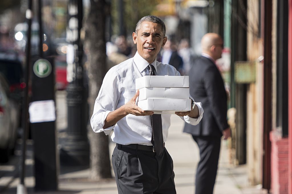 Barack Obama holding boxes of doughnuts