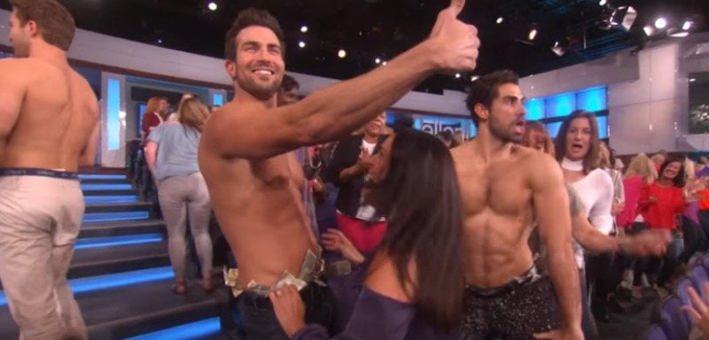 Bryan is stripping on The Ellen DeGeneres Show and is giving a thumbs up.