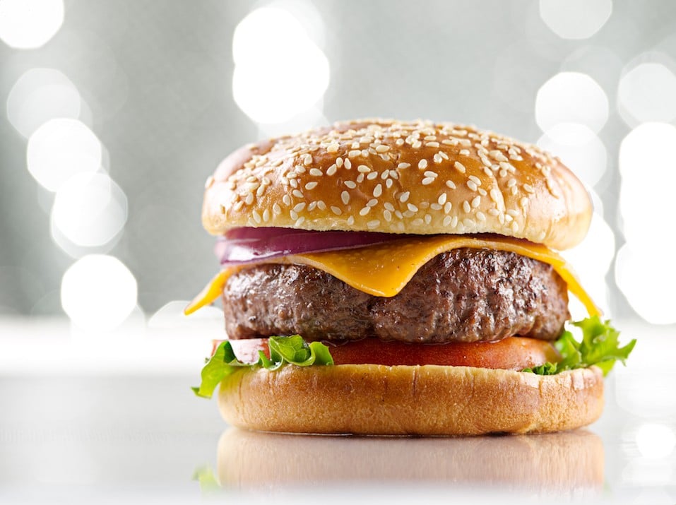 a cheeseburger on a sesame seed bun