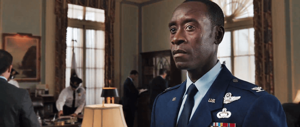 Don Cheadle, wearing a military uniform, looking off to the left of the frame