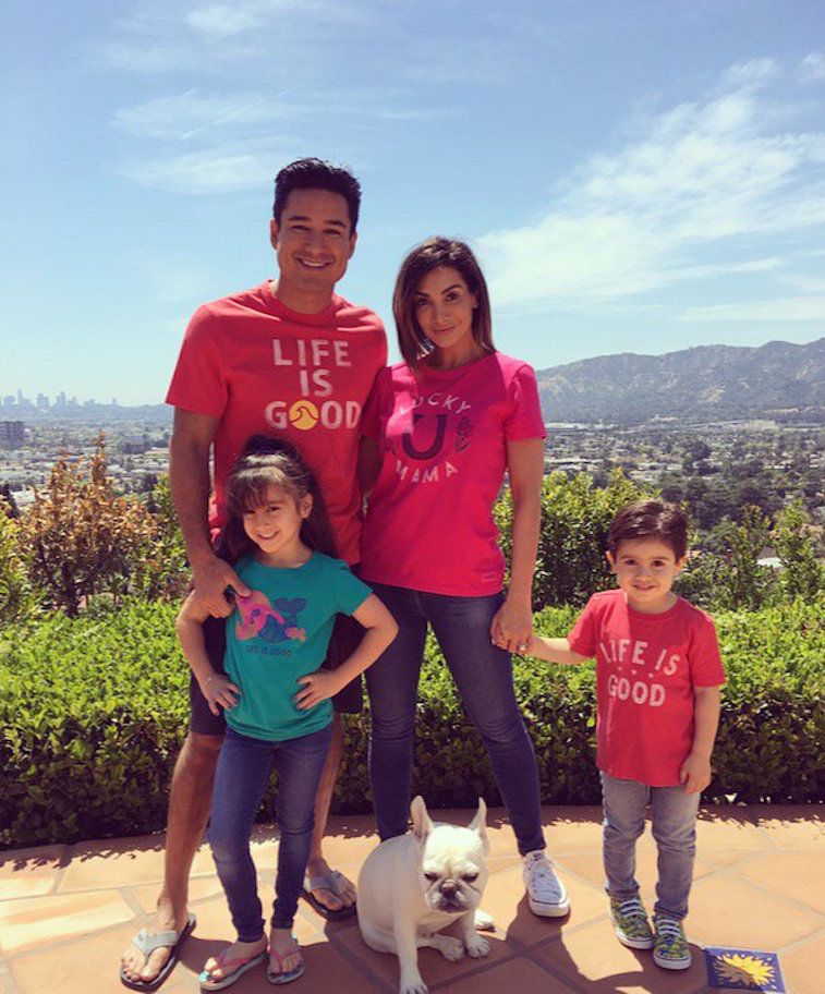 Mario Lopez, wife Courtney, and children Gia and Dominic and their dog standing on a mountain