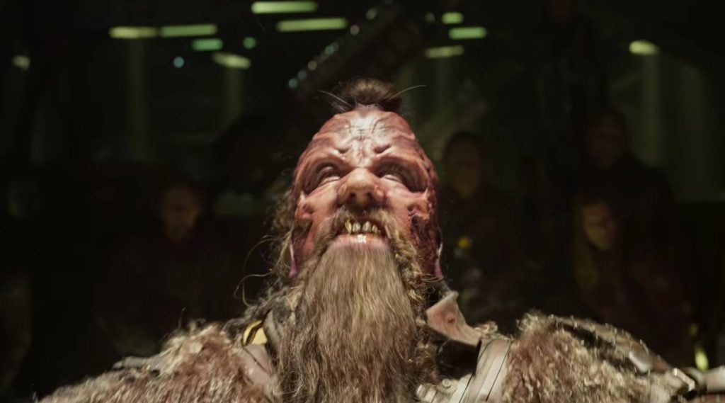 A deformed alien in Guardians of the Galaxy Vol. 2, looking up and glaring