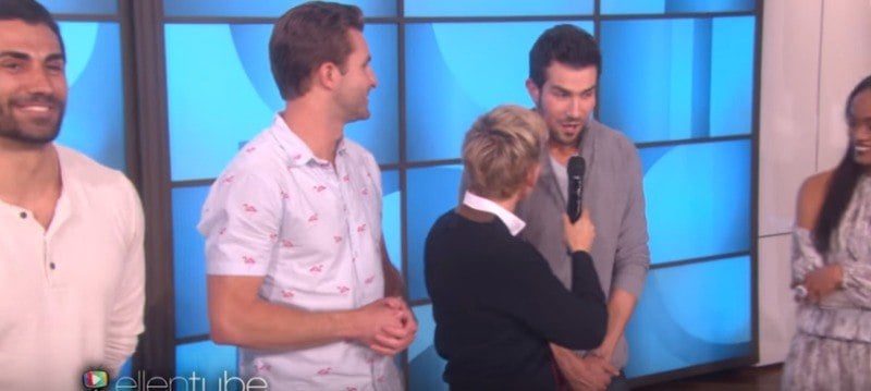 Brian is talking into a microphone that Ellen DeGeneres is holding.