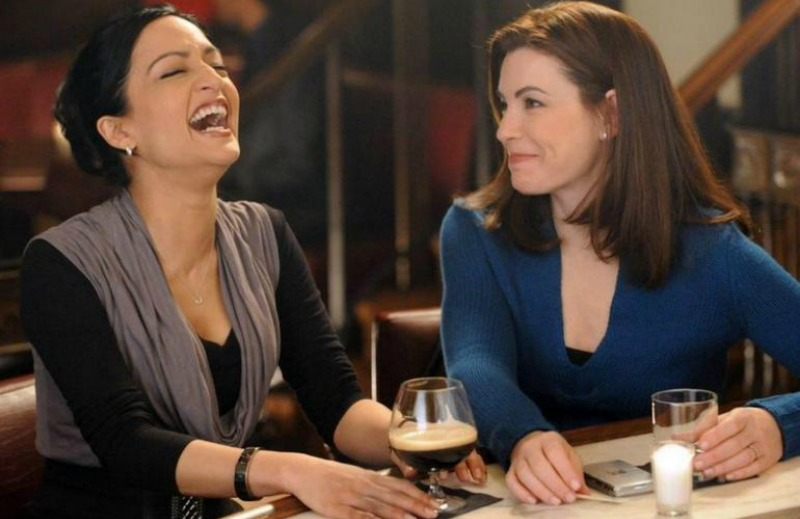 Alicia and Kalinda are sitting at bar together drinking happily.