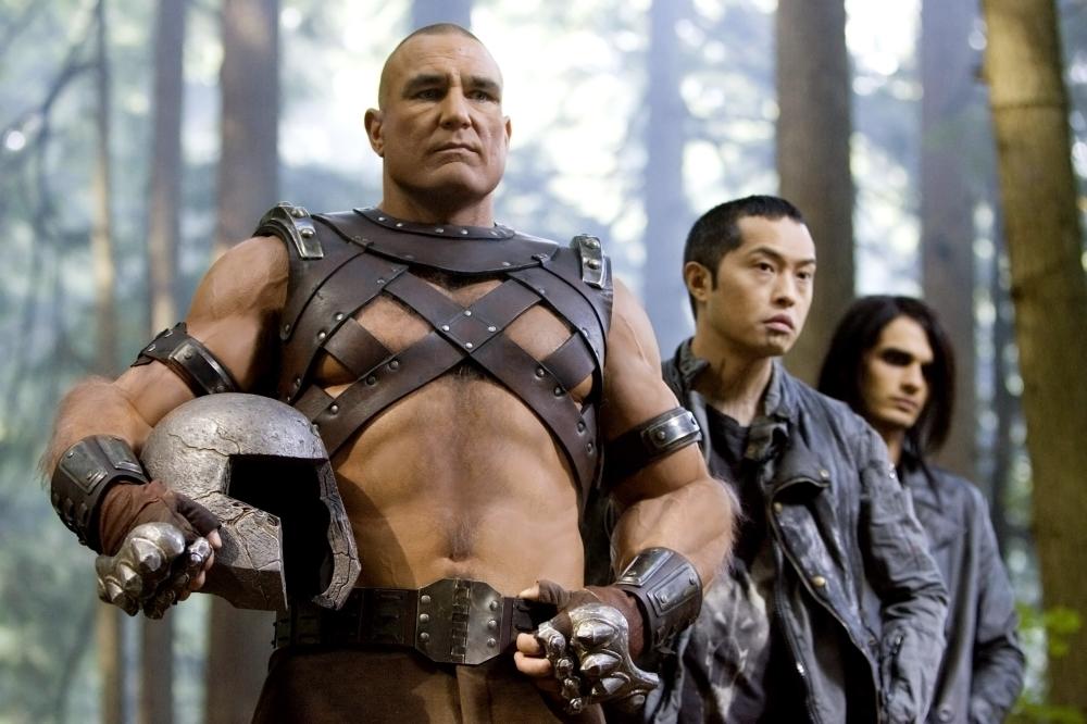 Vinnie Jones as Juggernaut, wearing a leather strapped shirt, and holding his helmet under his right arm