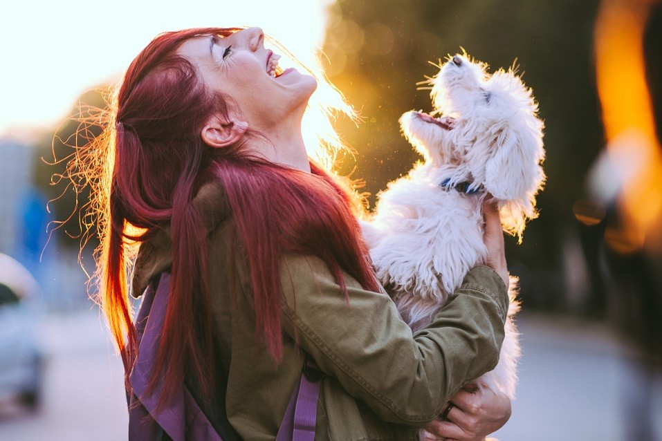 girl and dog smiling together