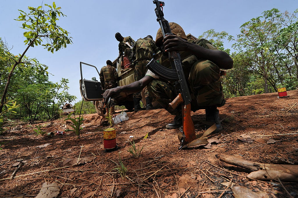 A Chadian soldier serving with the African-led MISCA force heating his daily ration during a patrol