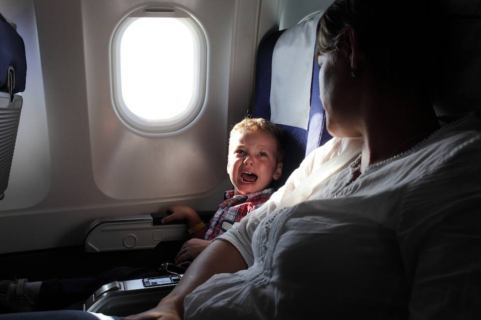 Crying boy on airplane