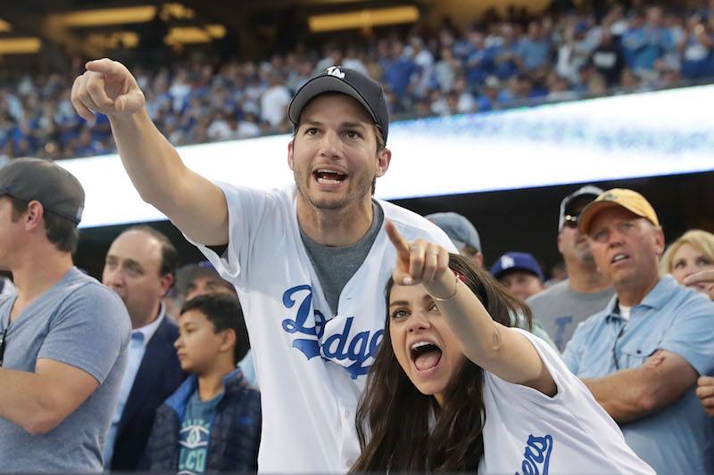 Mila Kunis and Ashton Kutcher cheer in support of the Los Angeles Dodgers