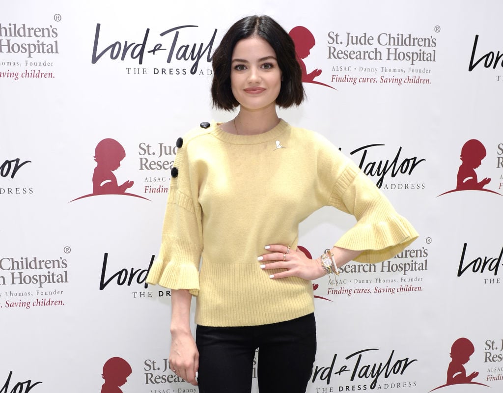 Lucy Hale poses with her hand on her hip at a Lord & Taylor event for St. Jude Children's Research Hospital