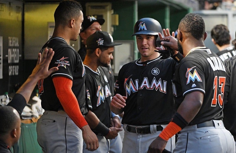 PITTSBURGH, PA - JUNE 08: J.T. Realmuto #11 of the Miami Marlins celebrates with teammates in the dugout after coming around to score on an RBI single by Tyler Moore #28 in the fifth inning during the game against the Pittsburgh Pirates at PNC Park on June 8, 2017 in Pittsburgh, Pennsylvania.