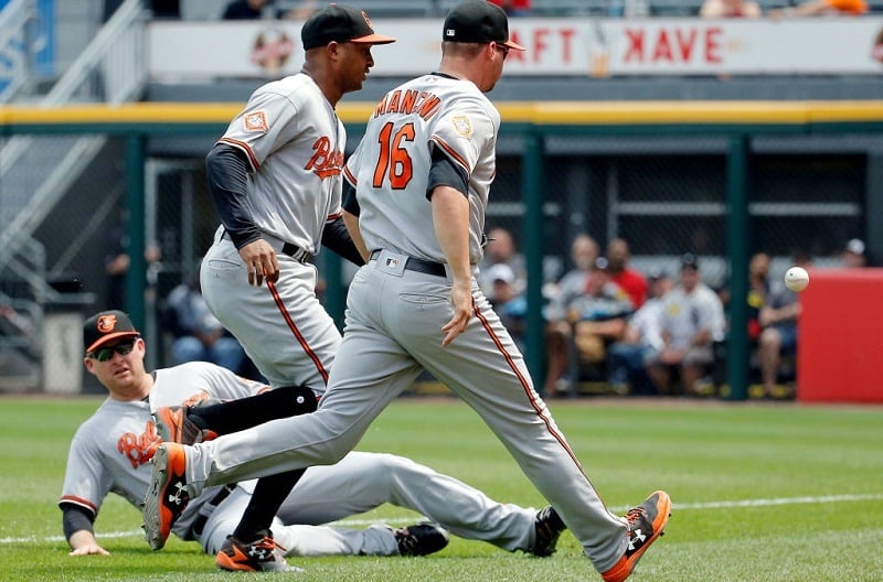 Three Baltimore Orioles converge on but miss a foul ball at Guaranteed Rate Field on June 15, 2017 in Chicago, Illinois.