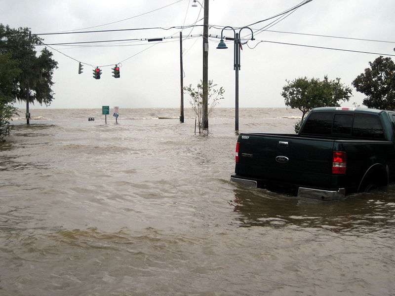 flooded road with truck stuck in water