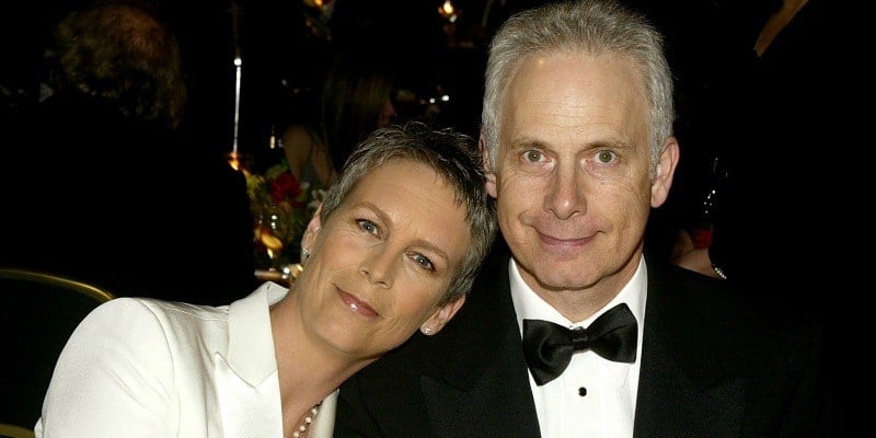 Jamie Lee-Curtis is resting her head on Christopher Guest's shoulder.
