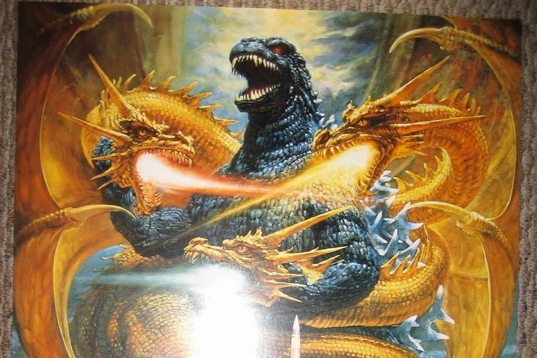 King Ghidorah, with his three heads all blowing a stream of flames directly at Godzilla's chest