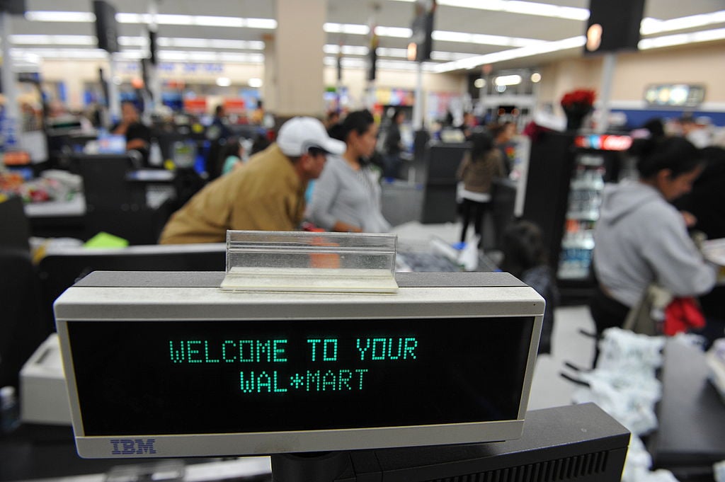 Shoppers wait in line to pay