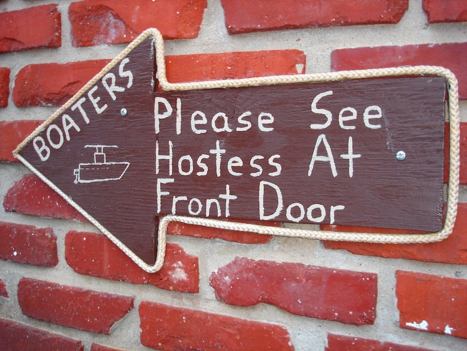 Sign that says "boaters, please see hostess at front door"