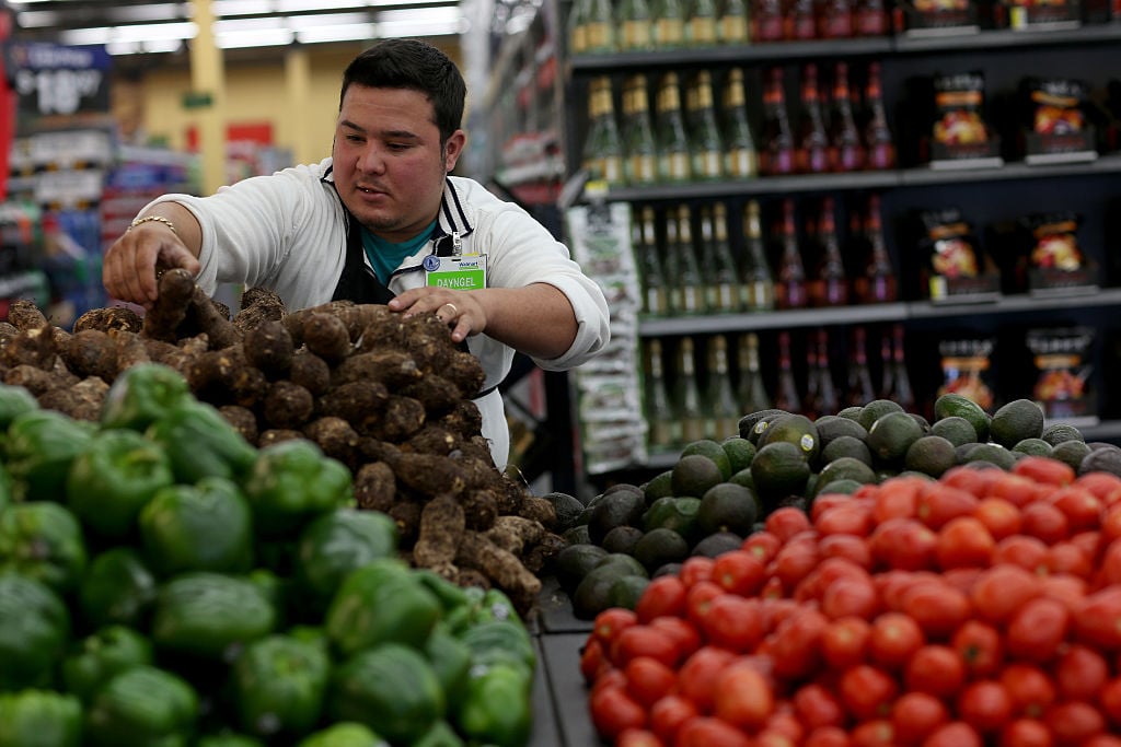 man stocking produce