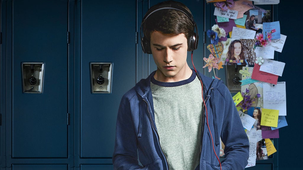 Clay listens to headphones in front of school lockers in 13 Reasons Why