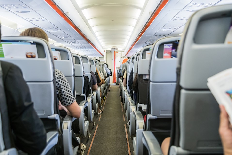 airplane with passengers on seats waiting to take off