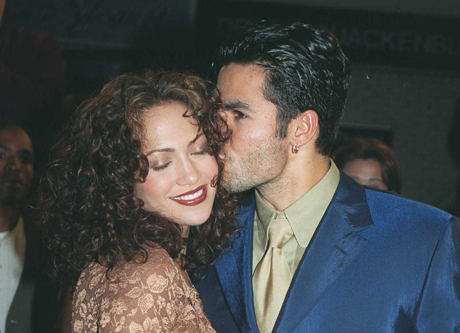 Ojani Noa kisses Jennifer Lopez on the cheek as she closes her eyes and smiles on the red carpet for the 'Anaconda' movie premiere.