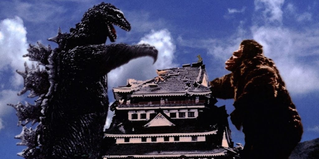 Godzilla preparing to fight King Kong, with each standing on either side of a large pagoda