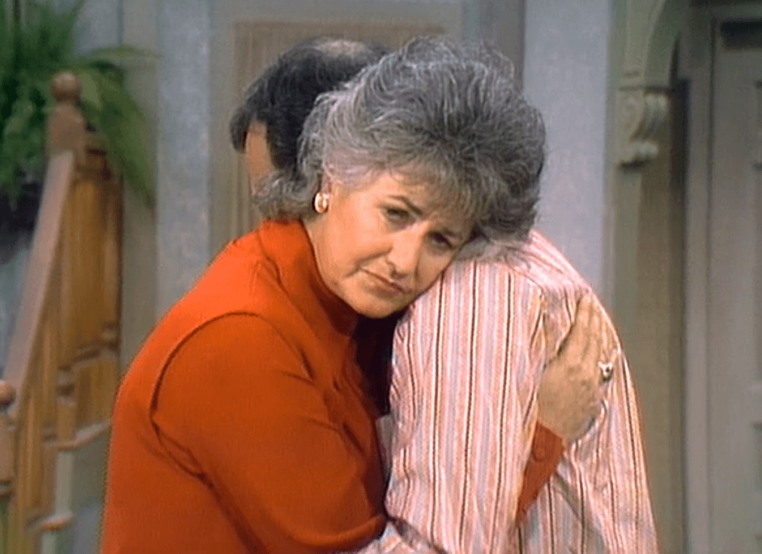 Maude hugs her husband while looking worried