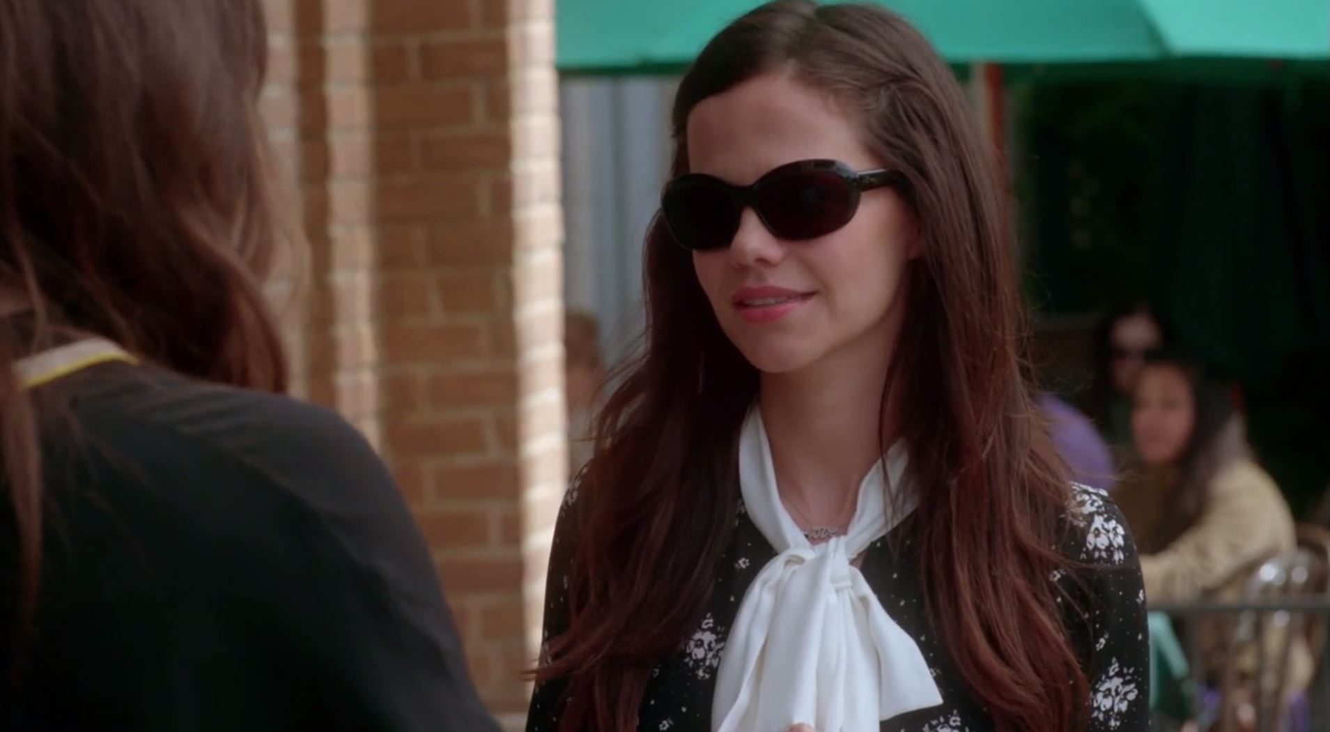 Jenna wearing her glasses looking at Alex